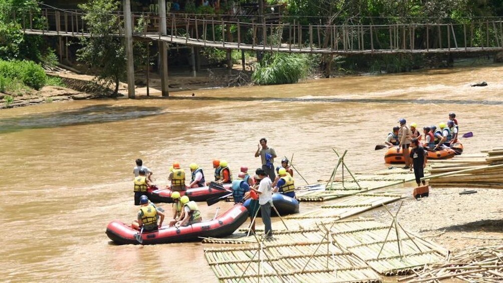 A couple of groups whitewater rafting on the Mae Taeng River