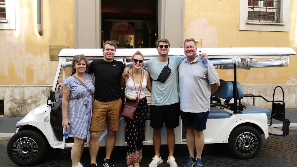 Group of tourists pose in Rome, Italy