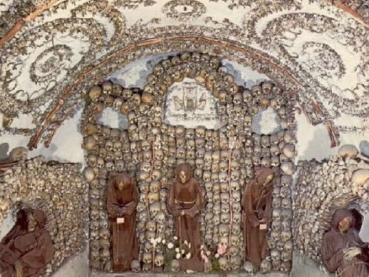 Wall of skulls inside the Capuchin Crypt in Rome, Italy