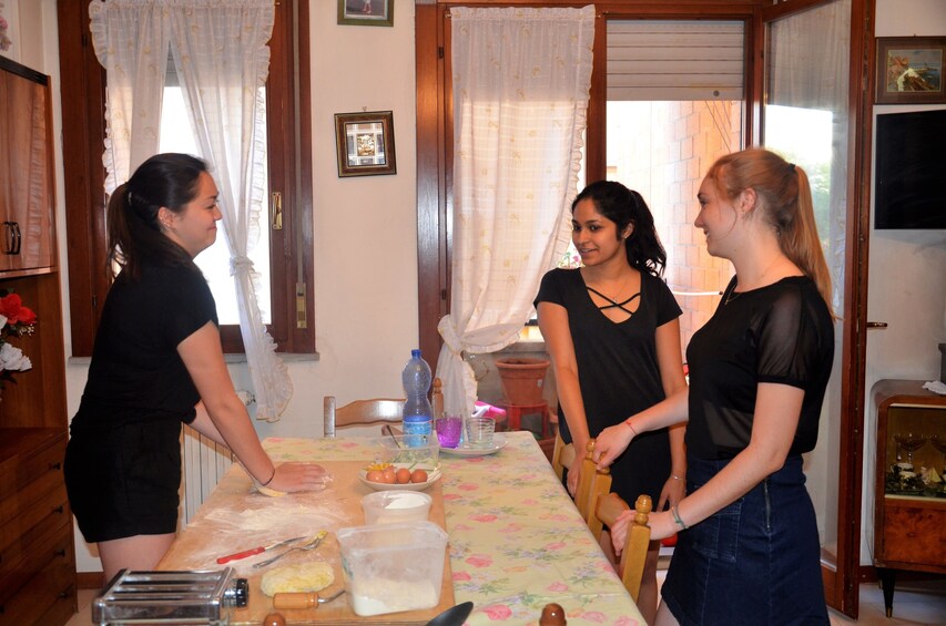 Show item 4 of 5. People make pasta together in Cortona, Italy