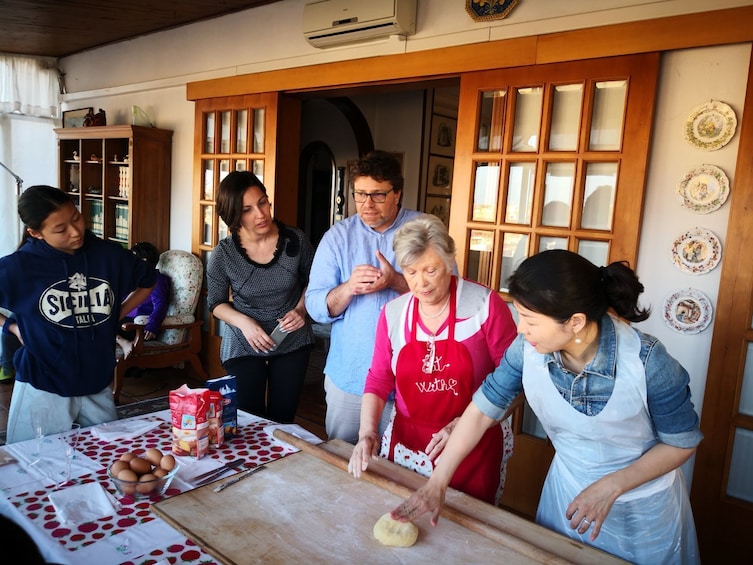 Show item 1 of 5. Instructor demonstrates how to roll out pasta dough in Cortona, Italy
