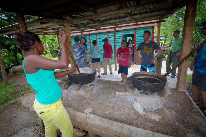 Woman demonstrates how to make food in large pot in Punta Cana