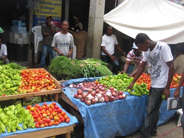 Man looks at produce at market in Punta Cana