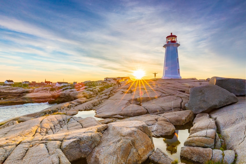 Rocks and lighthouse at sunset in Halifax, Nova Scotia