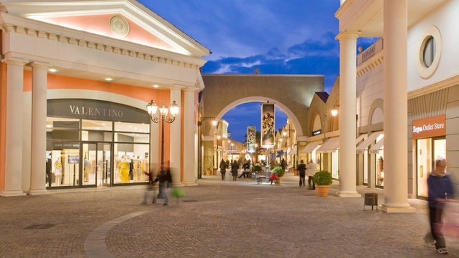 Outdoor Castel Romano shopping center at dusk