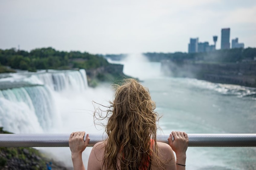 Closeup of woman looking out at Niagara Falls from a balcony