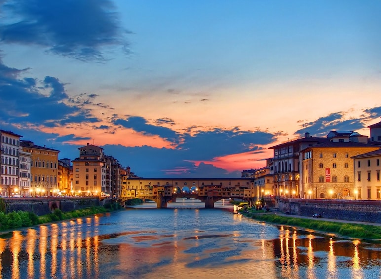 Show item 3 of 10. Sunset reflects on the River Arno