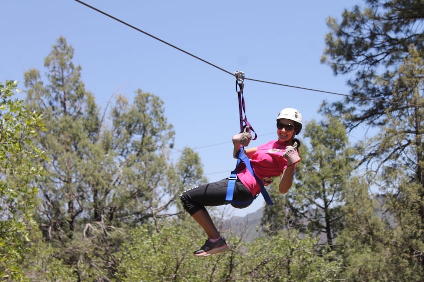 Woman poses while zip lining in Durango, Colorado