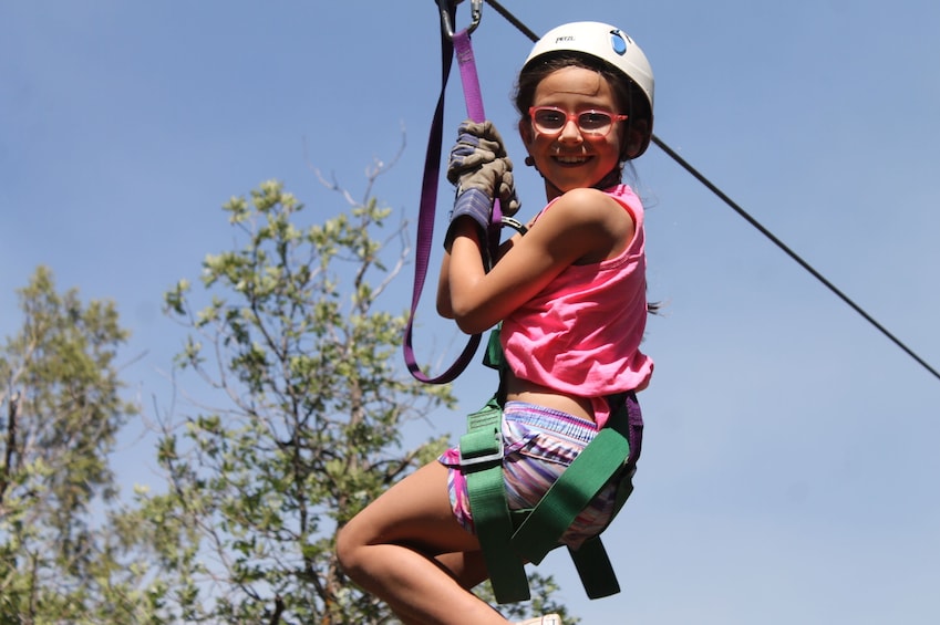 Little girl zip lines in Durango, Colorado