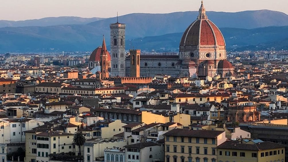 Aerial view of Florence and its cathedral with mountains in the background