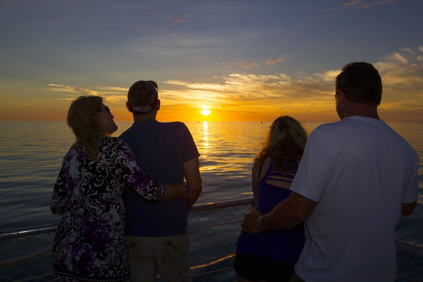 Two couples watch the sunset on cruise in Key West