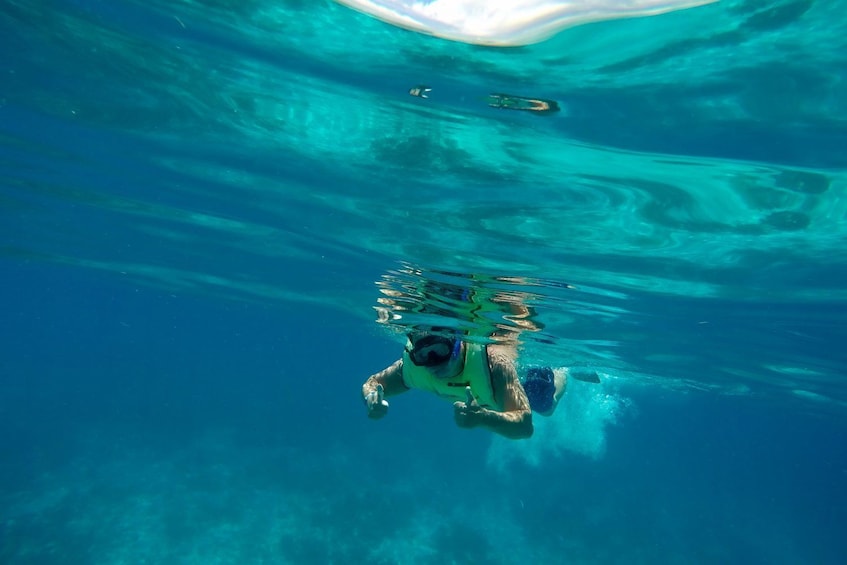 Snorkeler gives thumbs up under water