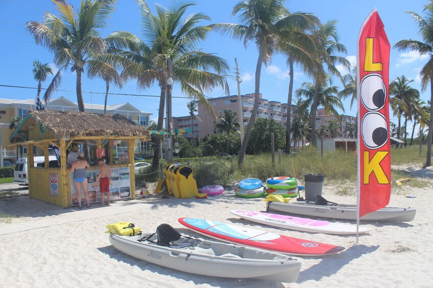 Canoes, surfboards and floaties on beach in Key West