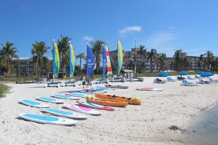 Kayaks and surfboards cover the beach in Key West, Florida