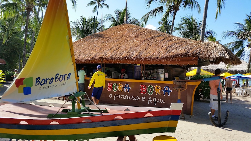 Boat and food stand on Carneiros Beach