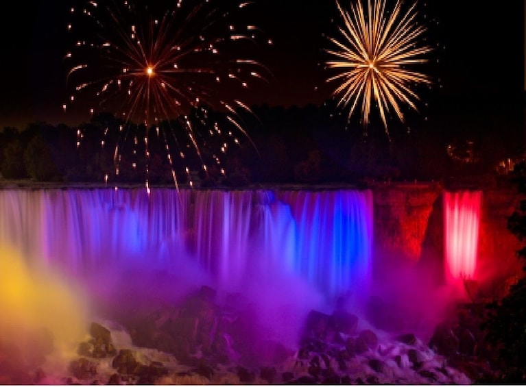 Niagara Falls lit up purple and red during a fireworks show