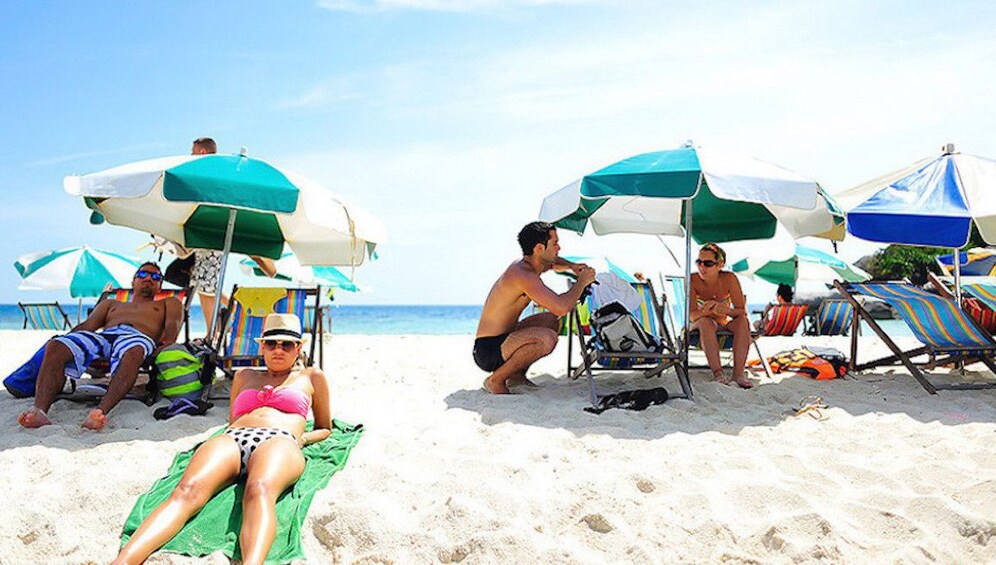 Tourists enjoying the white sandy beach in Koh Tao