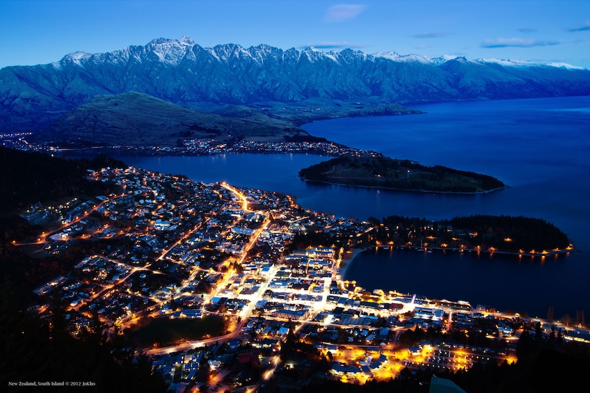 Aerial view of Queenstown lit up at night
