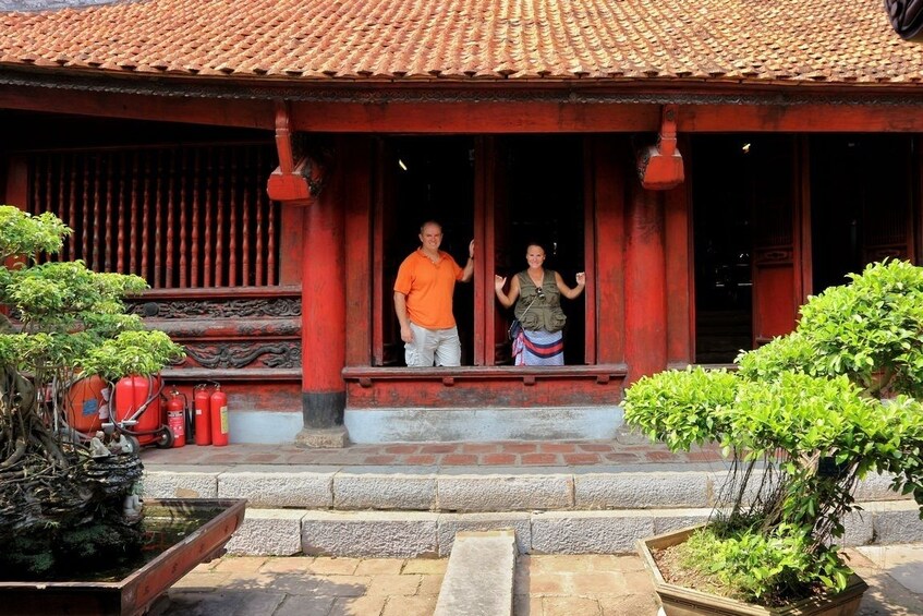 Couple pose at entrance of temple in Vietnam