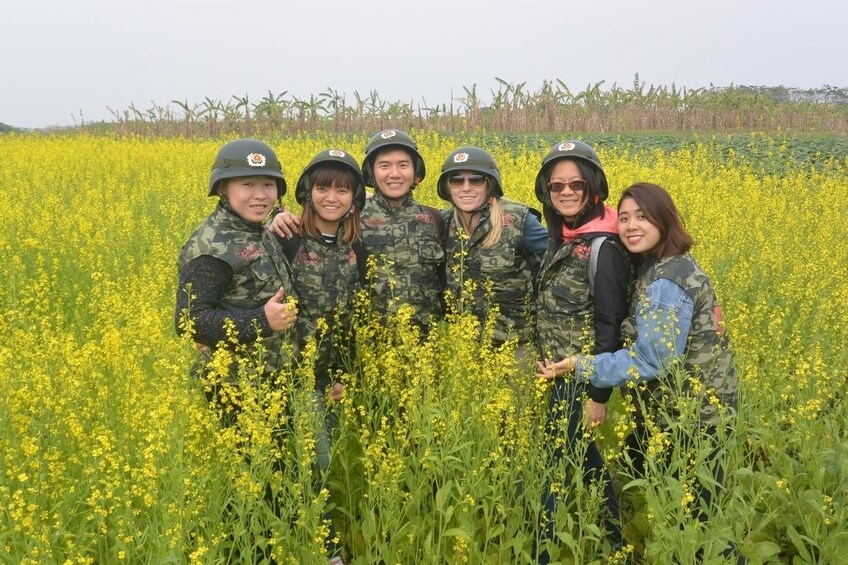 Tour guides pose at flower plantation in Vietnam