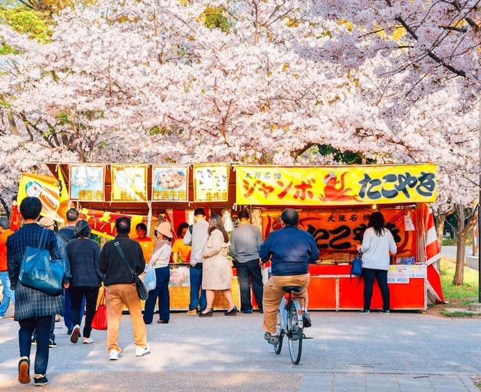 Food stall in front of cherry blossoms in Osaka, Japan