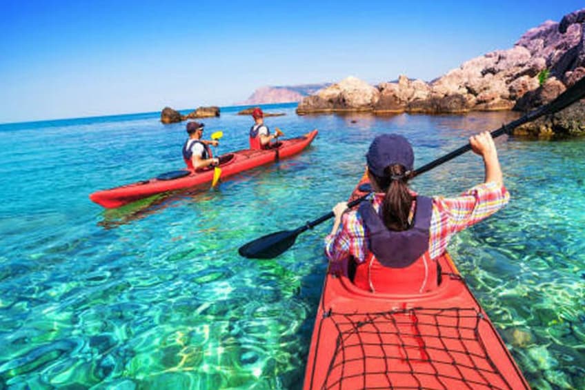 People kayak along the coast of Loreto, Mexico