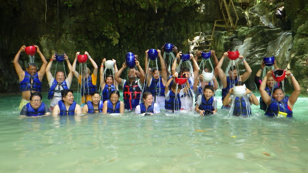 Group with helmets pose in the water in the Dominican Republic