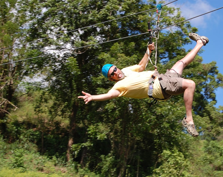 Man poses while zip lining in the Dominican Republic 