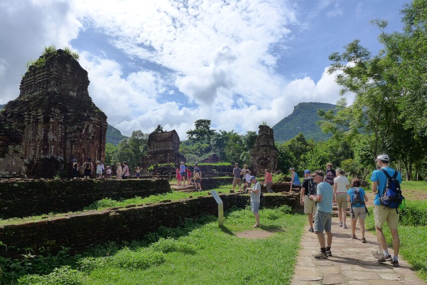 Tourists walk paths along Mỹ Sơn Sanctuary