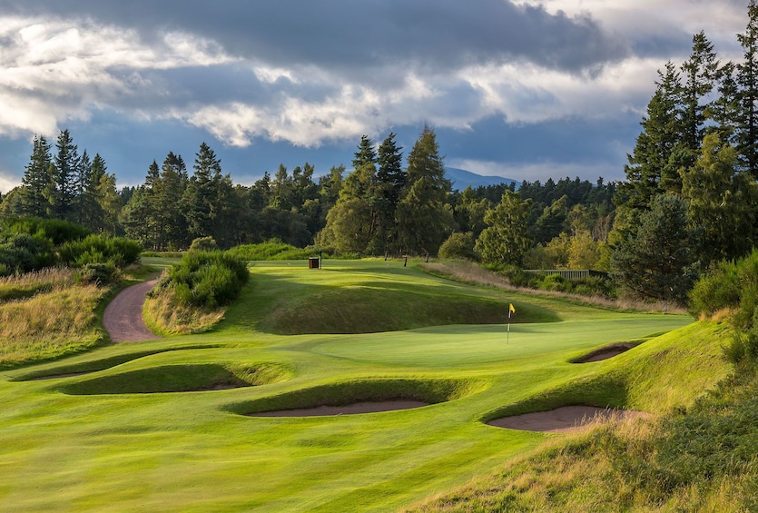 Golf course with sand traps on a cloudy day