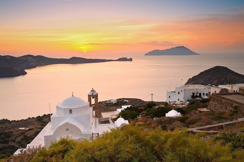 Sun sets over the Venetian Castle in Milos, Greece