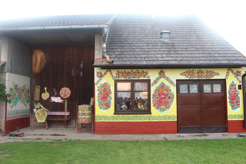 Small yellow house with painted flowers in Zalipie, Poland