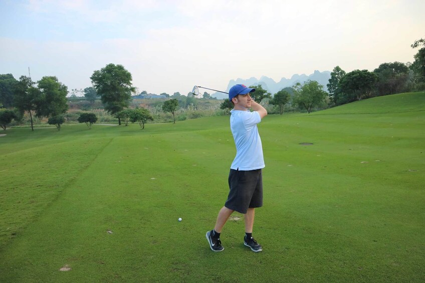 Man swings golf club at BRG Legend Hills Golf Resort