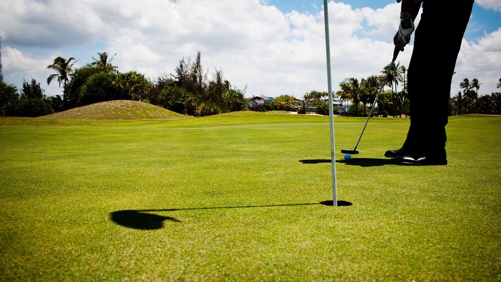 Closeup of golfer putting on the green