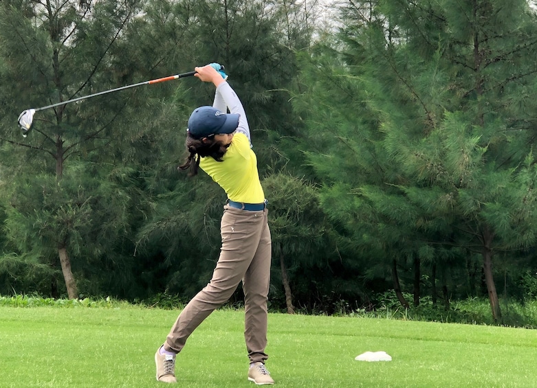 Golfer swings club on the golf course