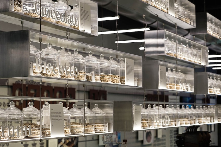 Wall with clear jars of different varieties of coffee bean