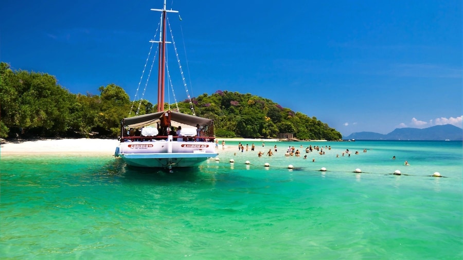 Large boat approaches beach in Angra Dos Reis, Brazil