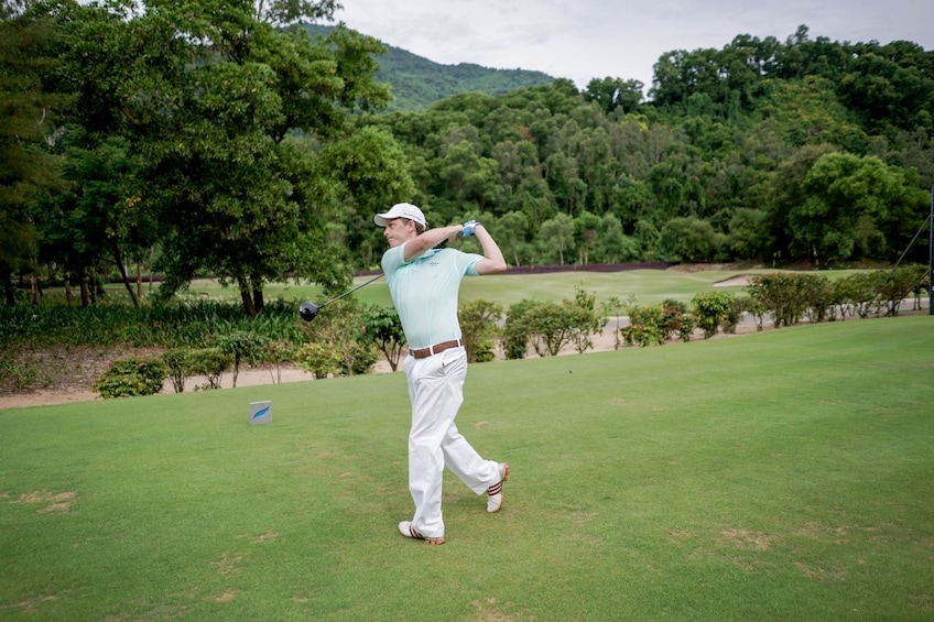 Man golfing at Laguna Lang Co Golf Club in Vietnam