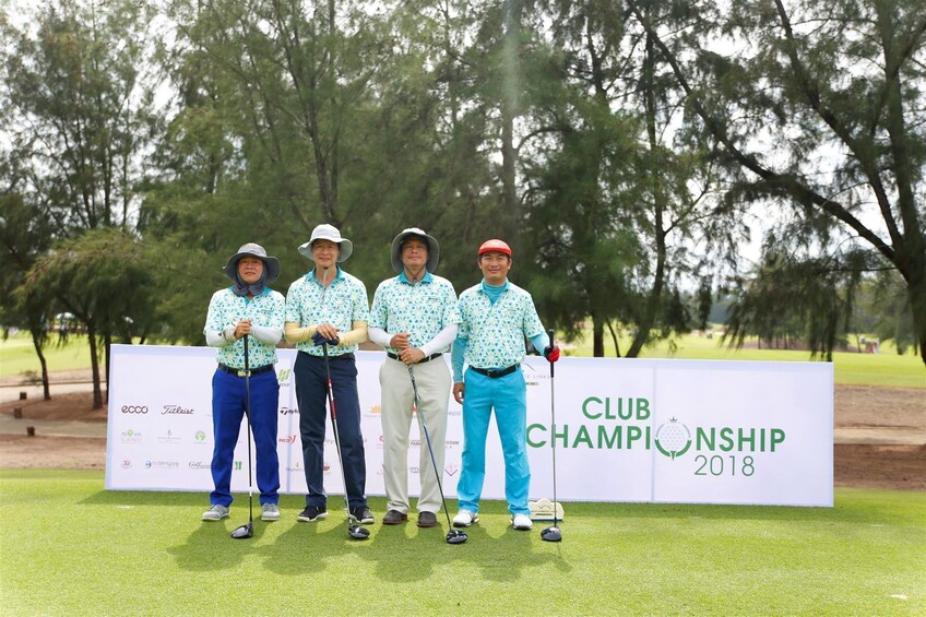 Golfers standing in front of a Club Championship 2018 sign 