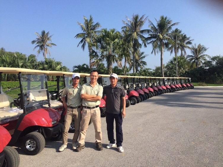 Men standing next to golf carts at Twin Doves Golf Club
