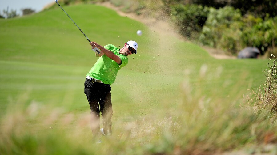Man golfing at The Bluffs Ho Tram Strip