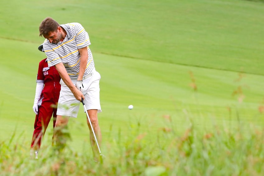 Man golfing at a golf course on a clear day