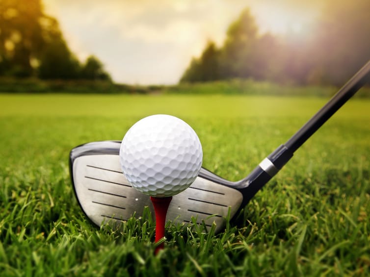 Closeup of golf club, ball and tee