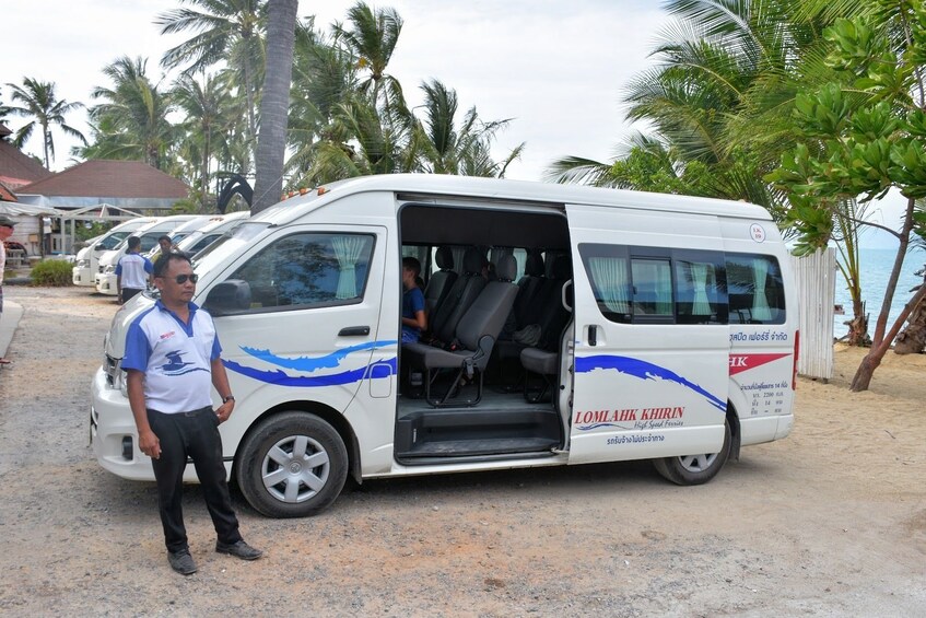 Driver poses with white van on Koh Phangan