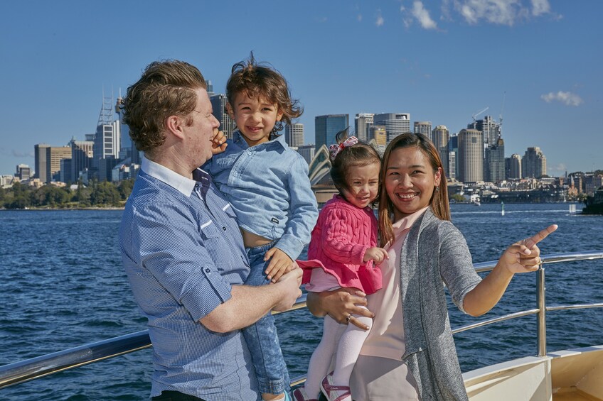 Family stands on deck of boat in Sydney Harbor