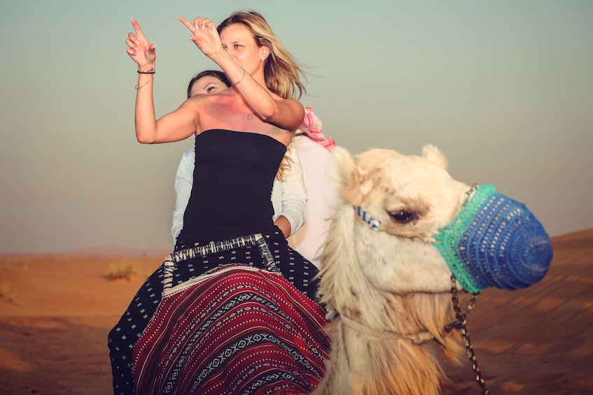 Women on a camel ride in Dubai desert