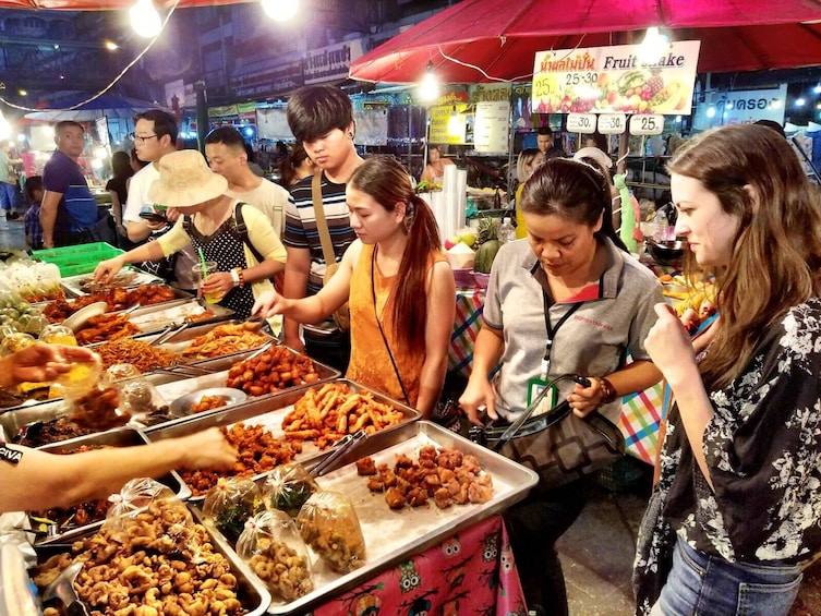 Tourists look at hot food at Chiang Mai market 