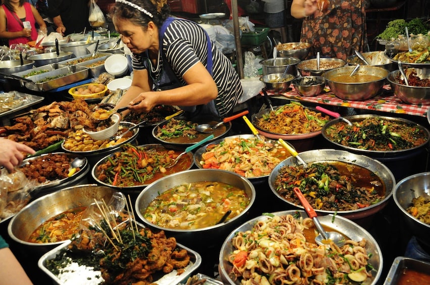 Many skillets of hot food at Chiang Mai market