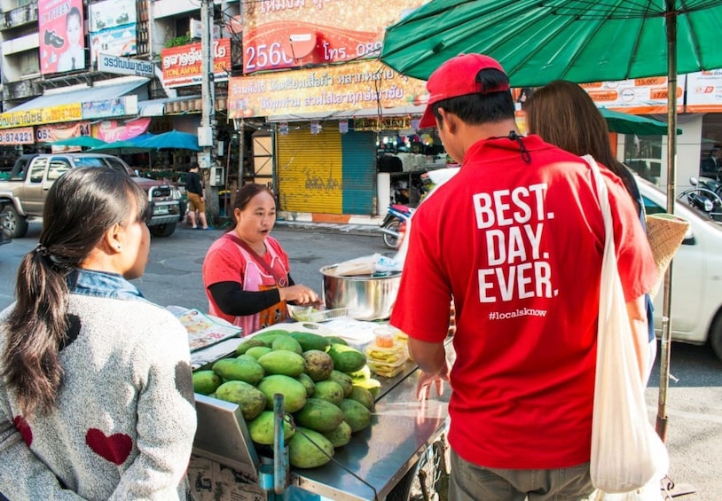 Tourist buys something at Chiang Mai market