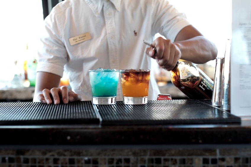 Bartender pours two drinks aboard the Majestic